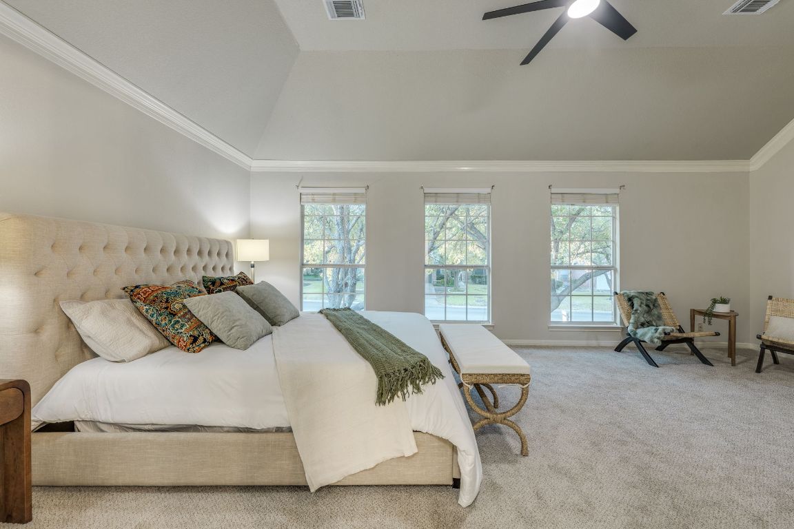 10701 Redmond Road Austin, TX 78739 - Photo 26 of 39 a bedroom with a bed and a chandelier