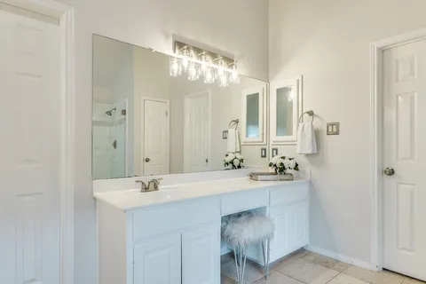 a bathroom with a sink double vanity and a mirror