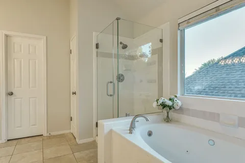 a bathroom with a tub shower and a sink