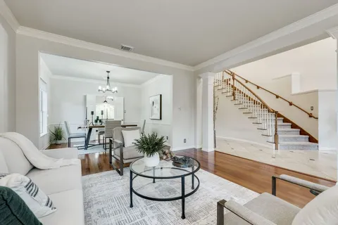 a living room with furniture and a chandelier