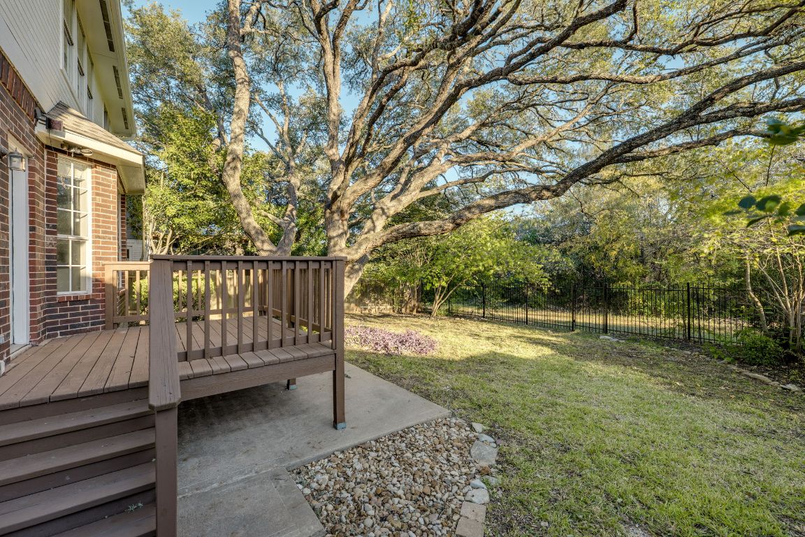 10701 Redmond Road Austin, TX 78739 - Photo 36 of 39 a view of a backyard with wooden fence and large trees