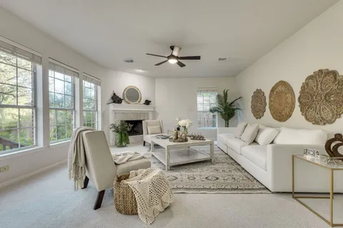 a living room with furniture fireplace and window