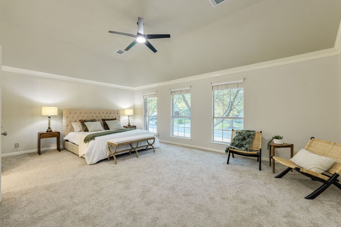 10701 Redmond Road Austin, TX 78739 - Photo 8 of 39 a spacious bedroom with a bed and a couch