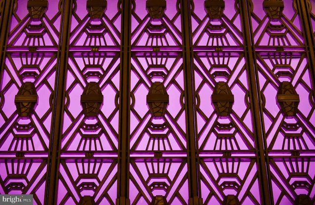 a lobby with furniture and a chandelier