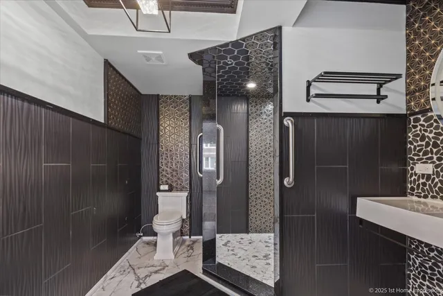a bathroom with a glass shower door