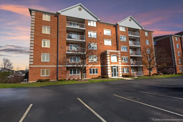 a front view of a residential apartment building with a street