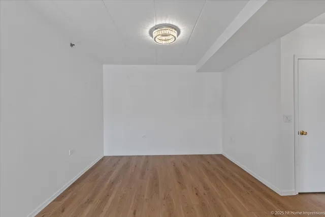 a view of a room with wooden floor and window
