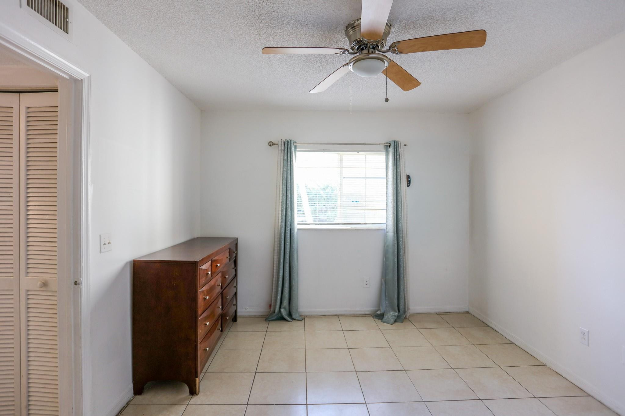 3680 North 56th Avenue, Unit 806 Hollywood, FL 33021 - Photo 11 of 30 an empty room with windows and fan
