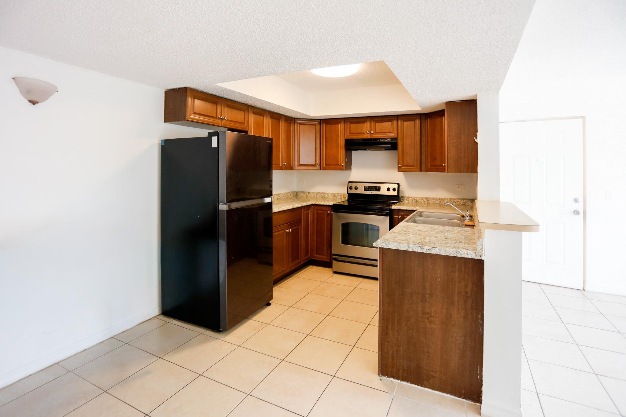 3680 North 56th Avenue, Unit 806 Hollywood, FL 33021 - Photo 3 of 30 a kitchen with stainless steel appliances granite countertop a refrigerator stove and sink