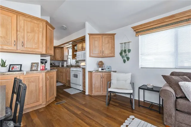 a living room with furniture a dining table and a window