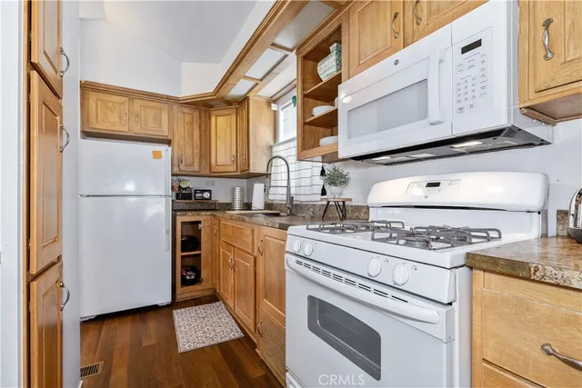a kitchen with a stove top oven and refrigerator