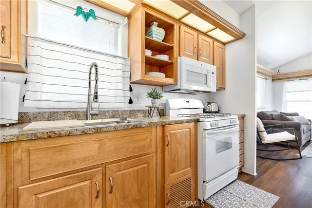 a kitchen with granite countertop a sink and a window