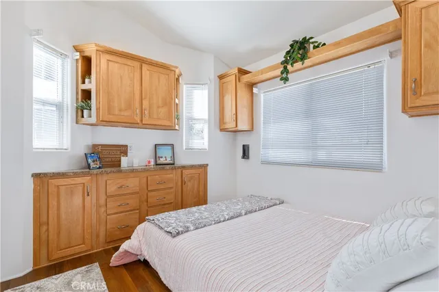 a bedroom with a bed dresser and a window