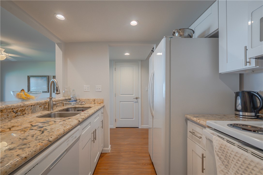 620 Fulton Beach Road, Unit 708 Rockport, TX 78382 - Photo 13 of 38 a bathroom with a granite countertop sink a mirror and vanity