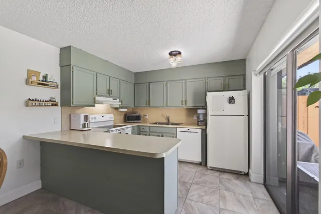 a white refrigerator freezer sitting inside of a kitchen