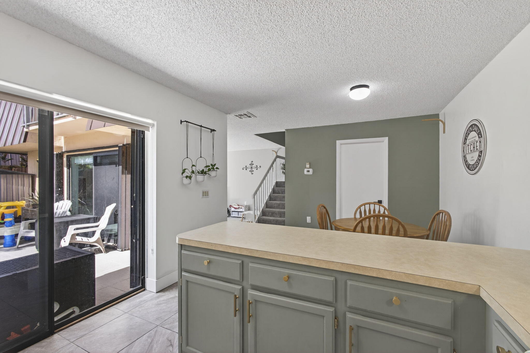 5680 Southeast Windsong Lane, Unit 345 Stuart, FL 34997 - Photo 19 of 54 a living room with furniture and a large window