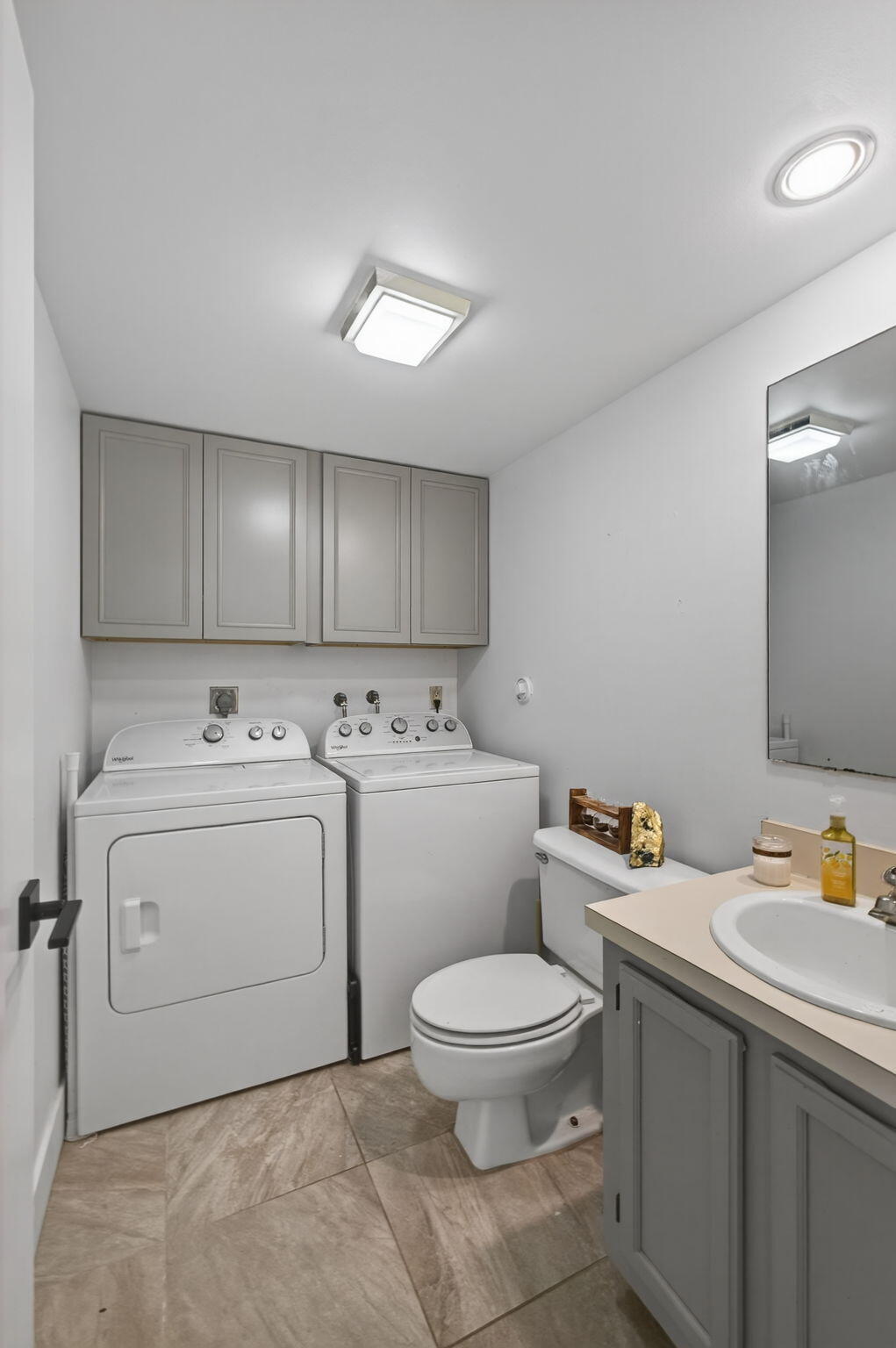 5680 Southeast Windsong Lane, Unit 345 Stuart, FL 34997 - Photo 22 of 54 a view of bathroom with a sink toilet and wooden floor