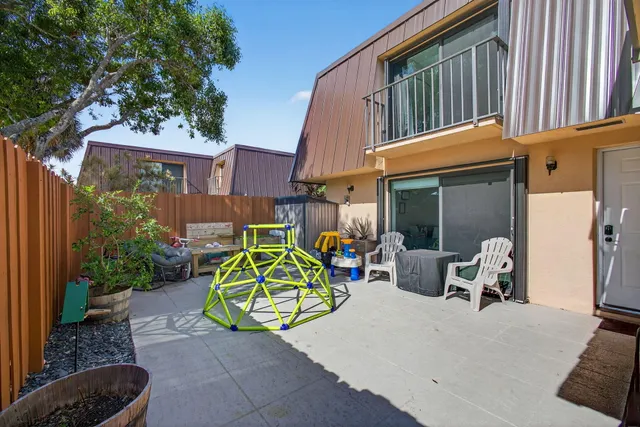a view of a chairs with a small yard and plants