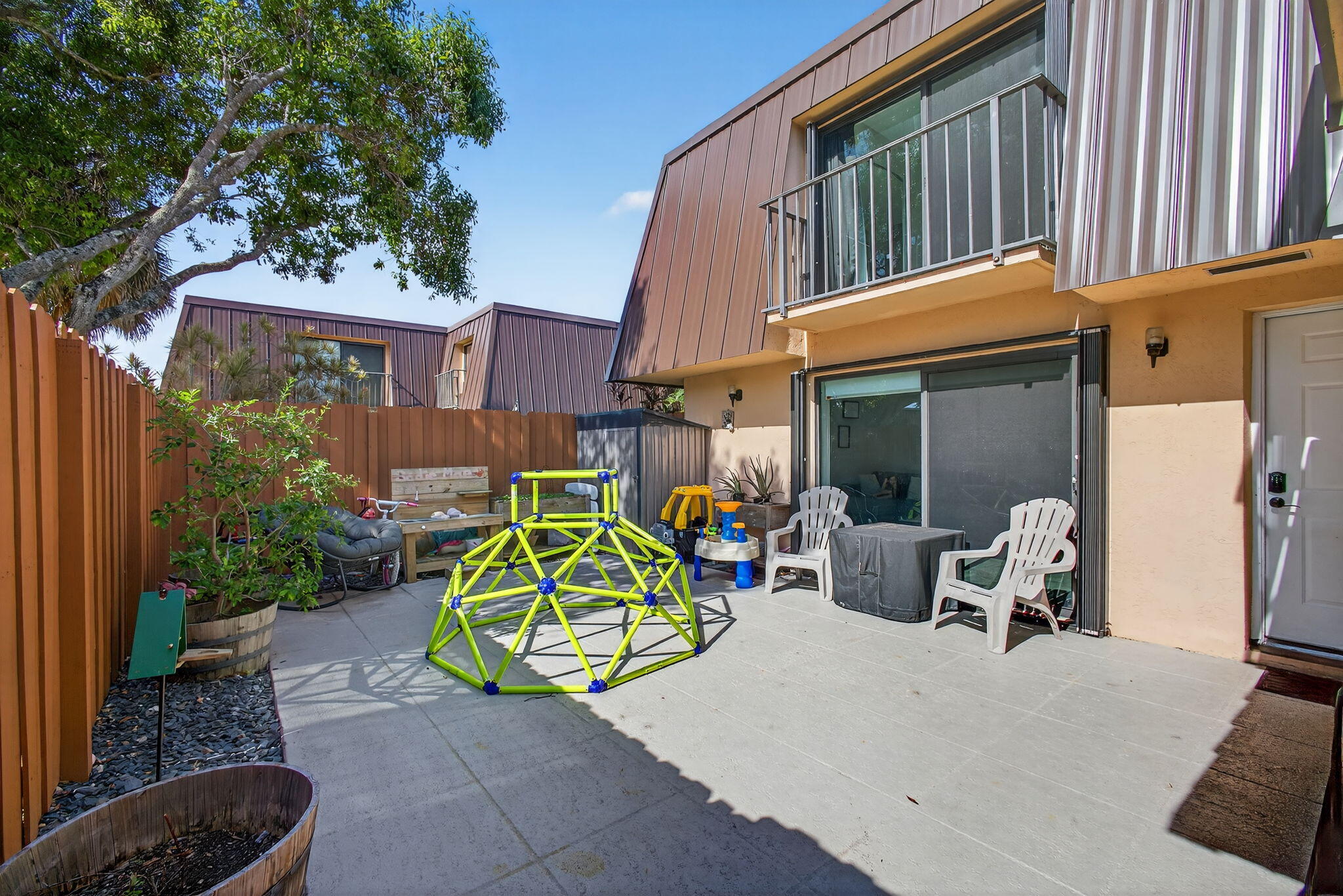 5680 Southeast Windsong Lane, Unit 345 Stuart, FL 34997 - Photo 3 of 54 a view of a house with a patio