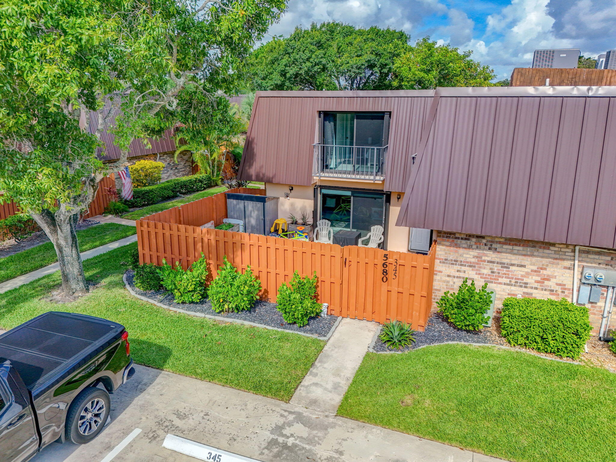 5680 Southeast Windsong Lane, Unit 345 Stuart, FL 34997 - Photo 39 of 54 a view of a yard with furniture and a garden