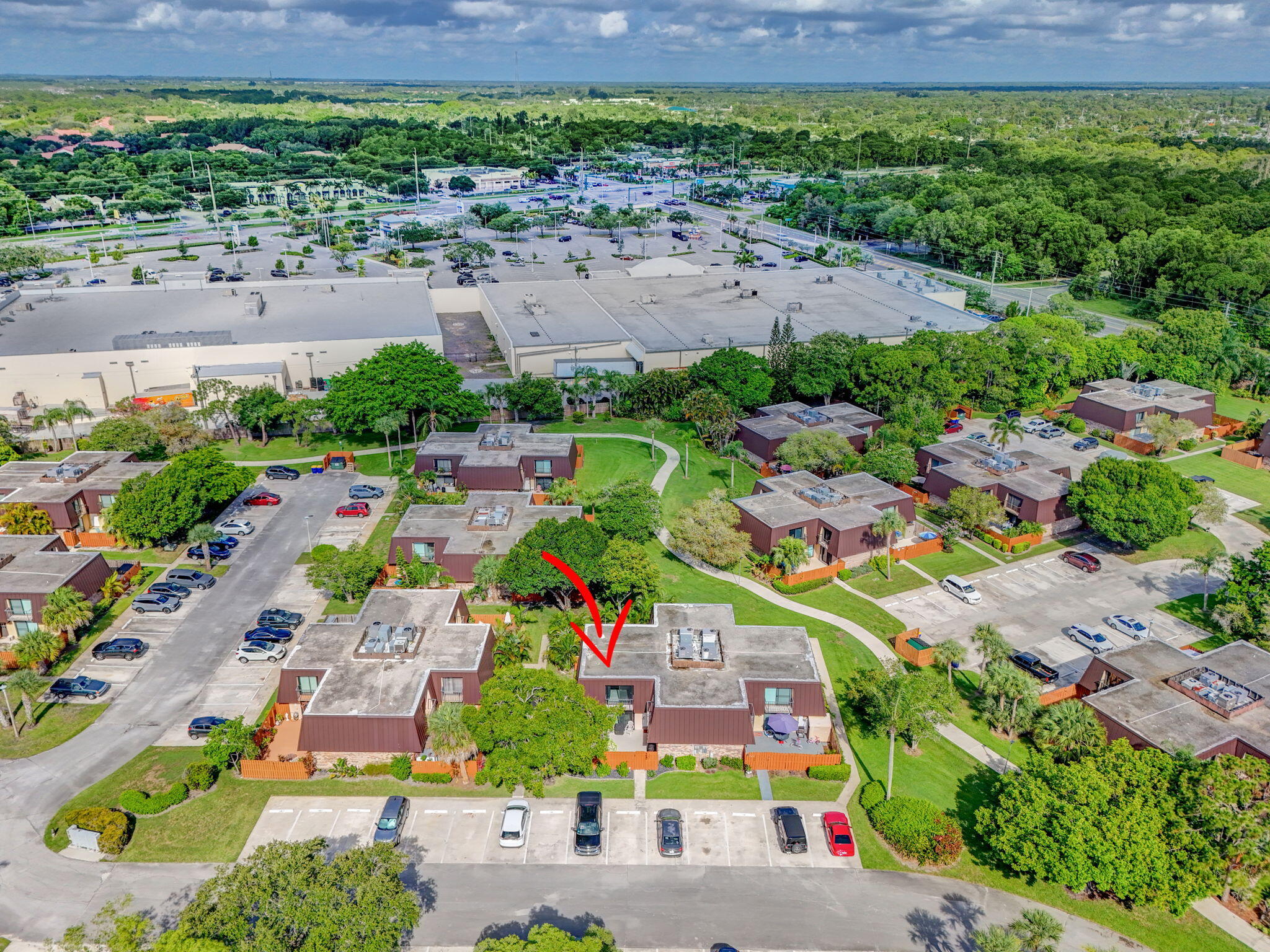 5680 Southeast Windsong Lane, Unit 345 Stuart, FL 34997 - Photo 43 of 54 an aerial view of a city