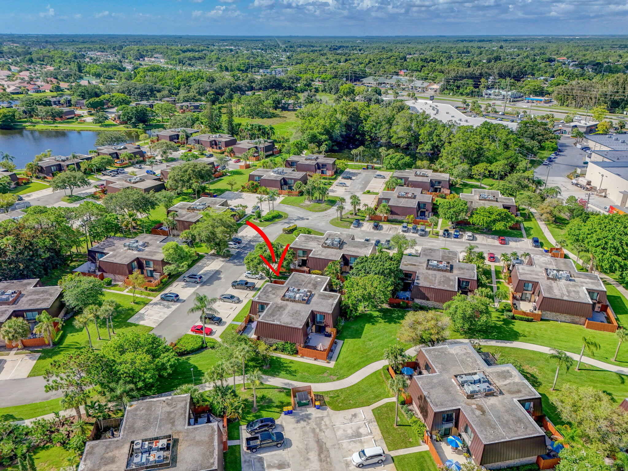 5680 Southeast Windsong Lane, Unit 345 Stuart, FL 34997 - Photo 45 of 54 an aerial view of multiple house