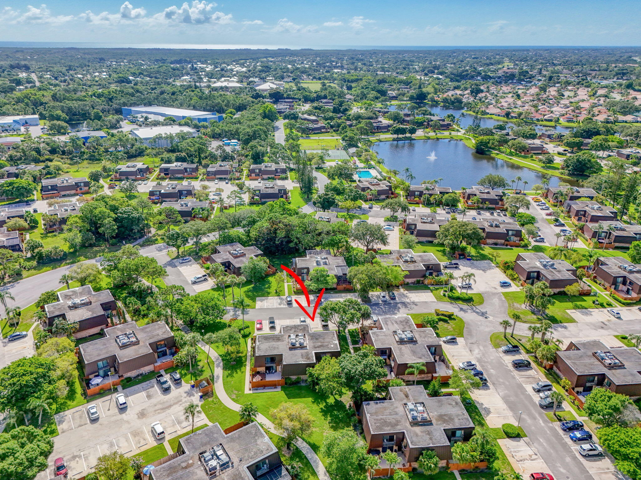 5680 Southeast Windsong Lane, Unit 345 Stuart, FL 34997 - Photo 47 of 54 an aerial view of a city with lots of residential buildings