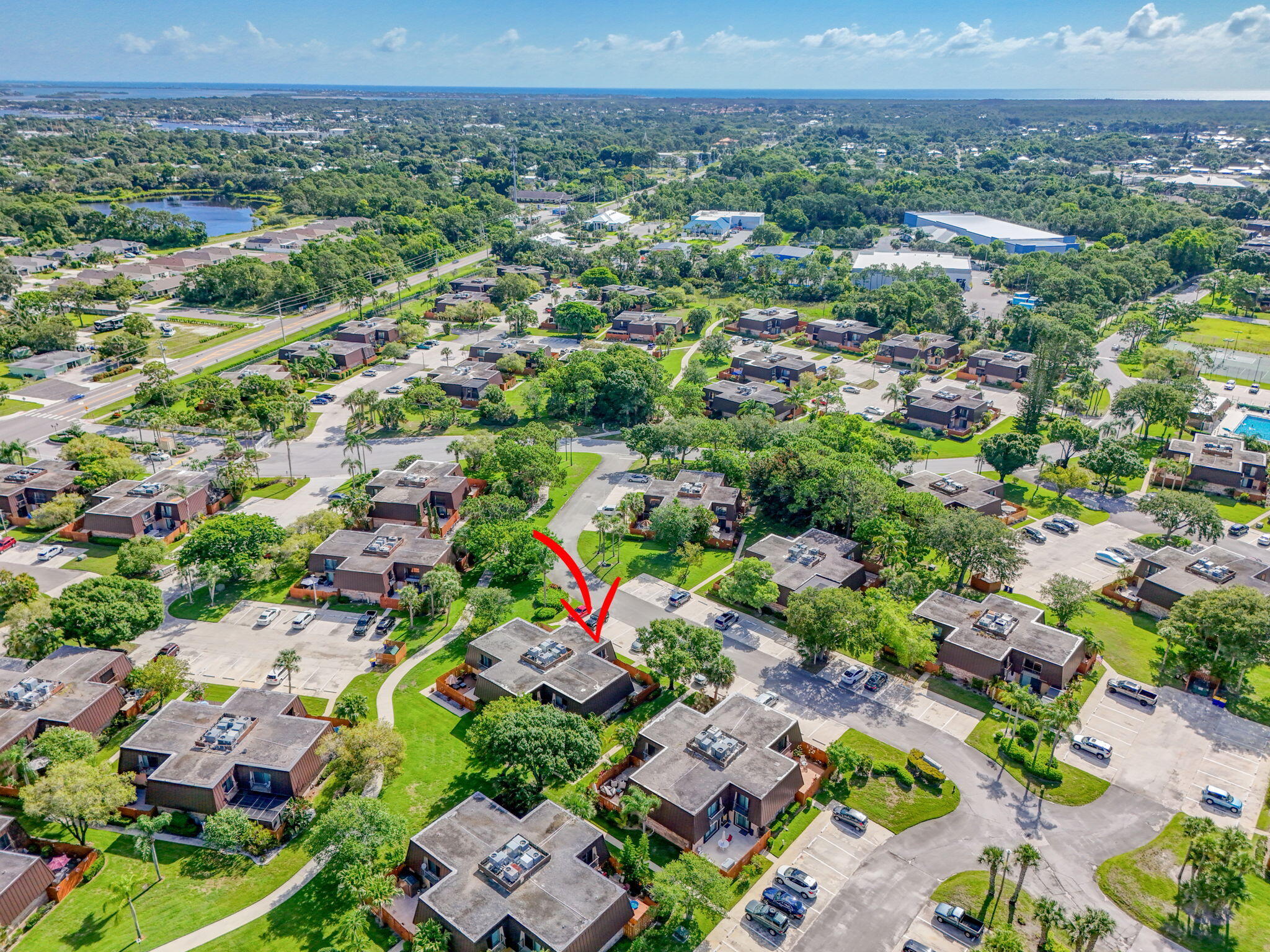 5680 Southeast Windsong Lane, Unit 345 Stuart, FL 34997 - Photo 48 of 54 an aerial view of multiple house