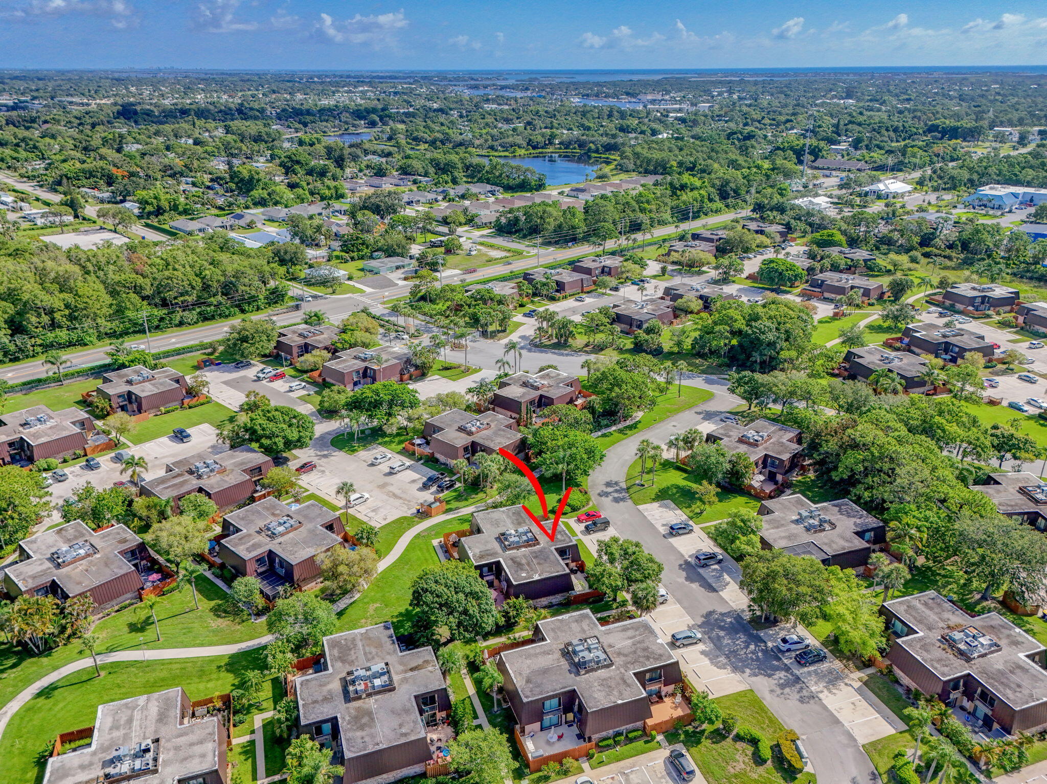 5680 Southeast Windsong Lane, Unit 345 Stuart, FL 34997 - Photo 49 of 54 an aerial view of multiple house