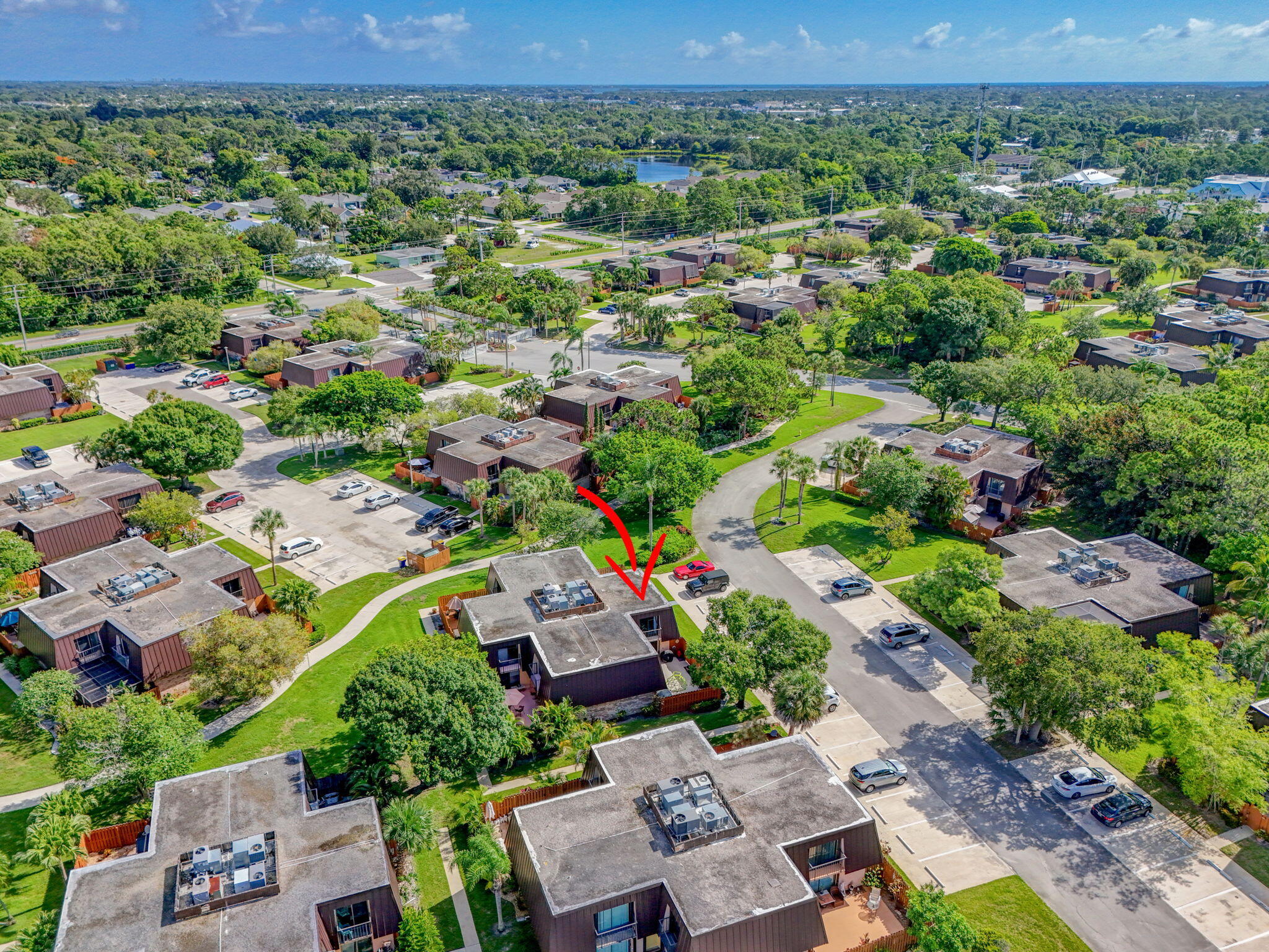 5680 Southeast Windsong Lane, Unit 345 Stuart, FL 34997 - Photo 50 of 54 an aerial view of residential houses with outdoor space