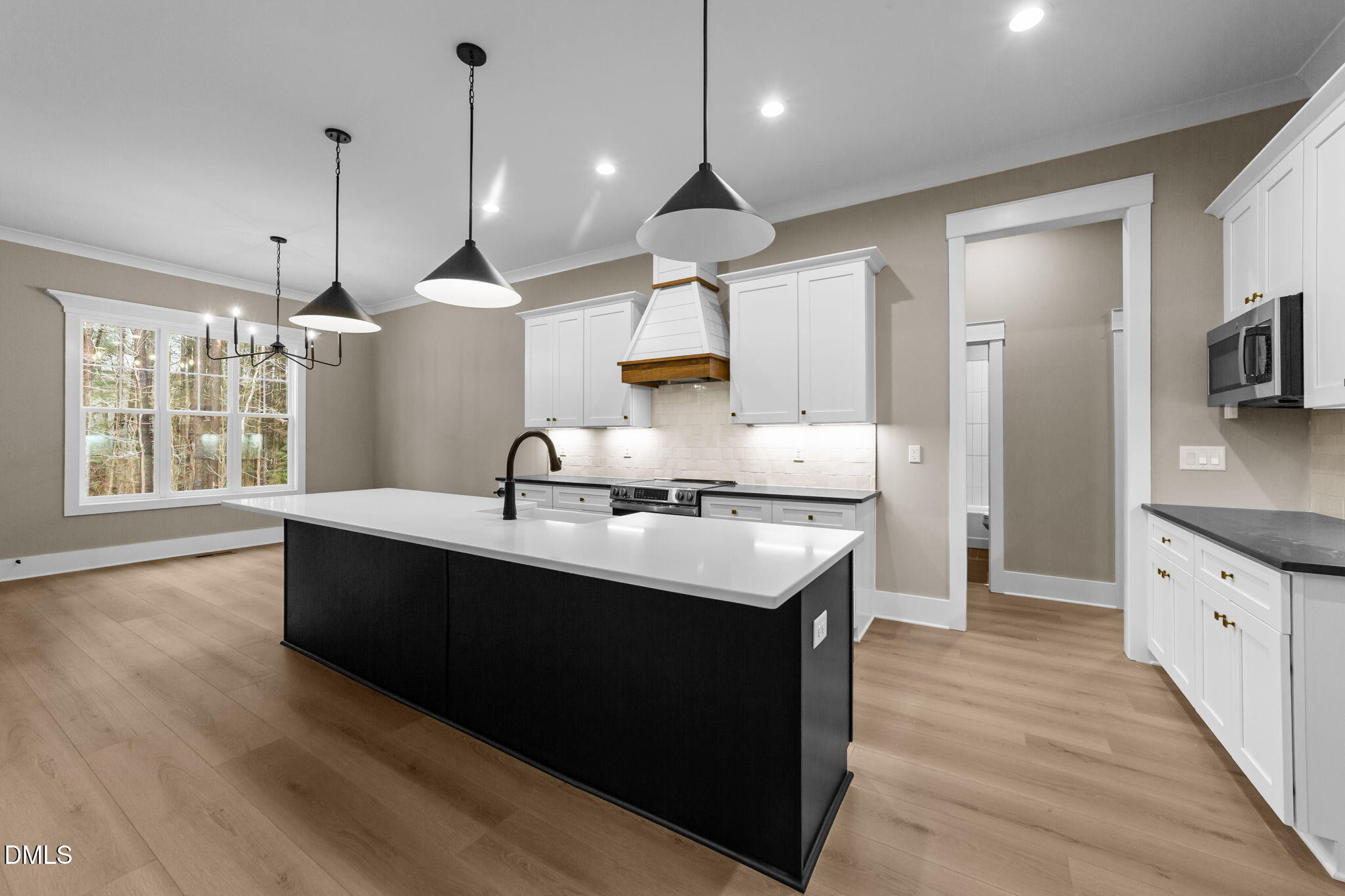2590 Lassiter Road Four Oaks, NC 27524 - Photo 15 of 55 a kitchen with stainless steel appliances granite countertop a sink a stove and a wooden floors