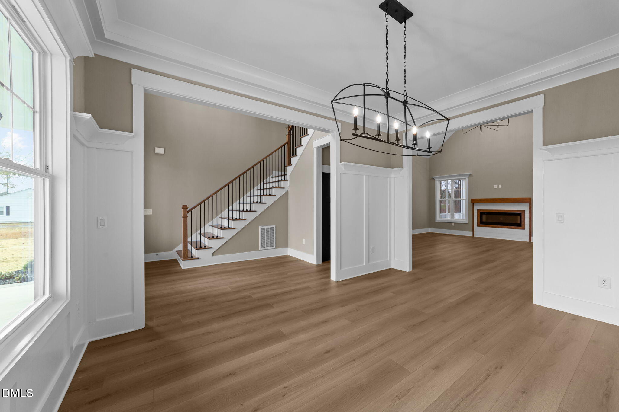 2590 Lassiter Road Four Oaks, NC 27524 - Photo 20 of 55 a view of an empty room with wooden floor kitchen view and a window