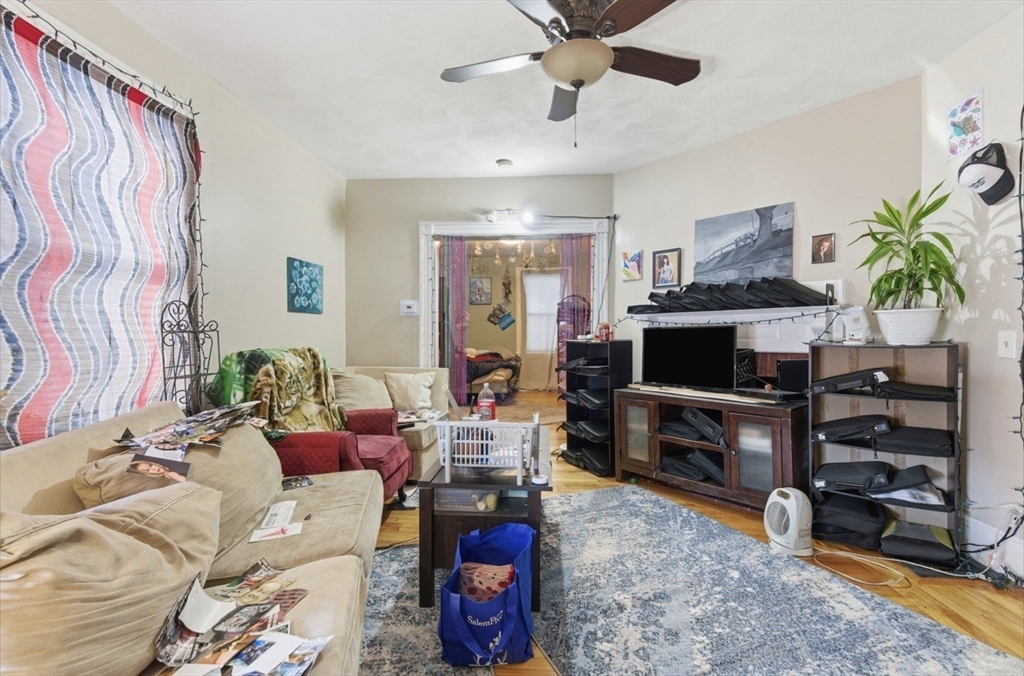 20 Central Avenue Danvers, MA 01923 - Photo 5 of 21 a living room with furniture a flat screen tv and a fireplace