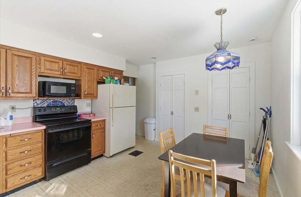 20 Central Avenue Danvers, MA 01923 - Photo 9 of 21 a kitchen with stainless steel appliances kitchen island granite countertop a stove refrigerator and microwave