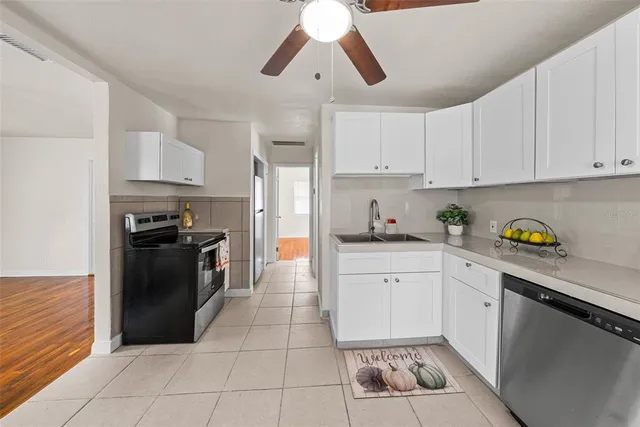 a kitchen with a sink window and refrigerator