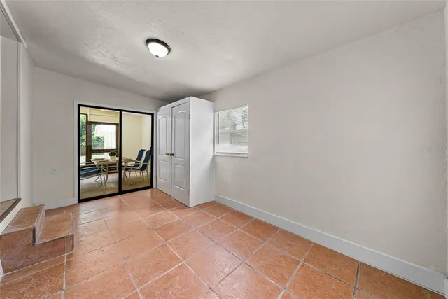 an empty room with entrance and windows