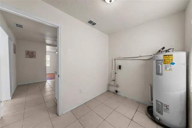 a view of a storage & utility room with refrigerator and mirror