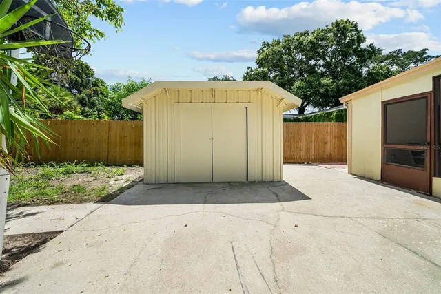 a view of a house with backyard and trees
