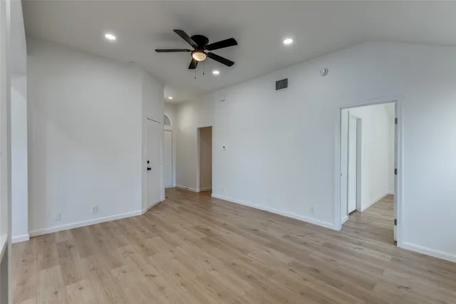 a view of an empty room and wooden floor