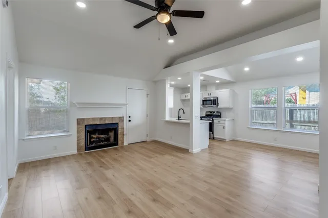 a view of kitchen and hall with furniture and a fireplace