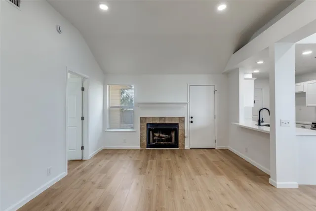 a view of a livingroom with a fireplace a fireplace and wooden floor