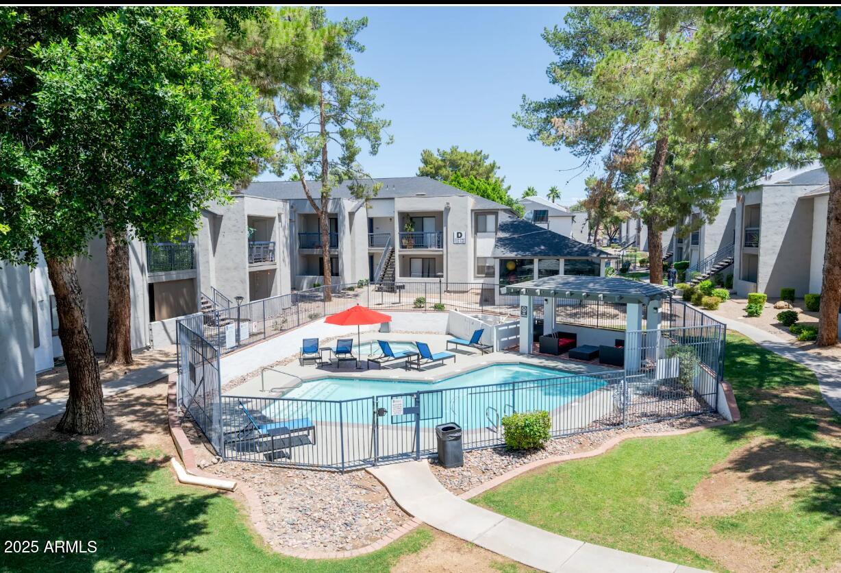 2311 East Union Hills Drive, Unit 21 Phoenix, AZ 85024 - Photo 1 of 13 a front view of a house with garden and sitting area