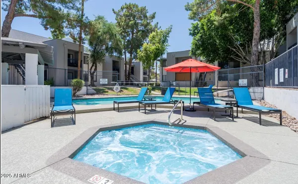 swimming pool with outdoor seating and yard