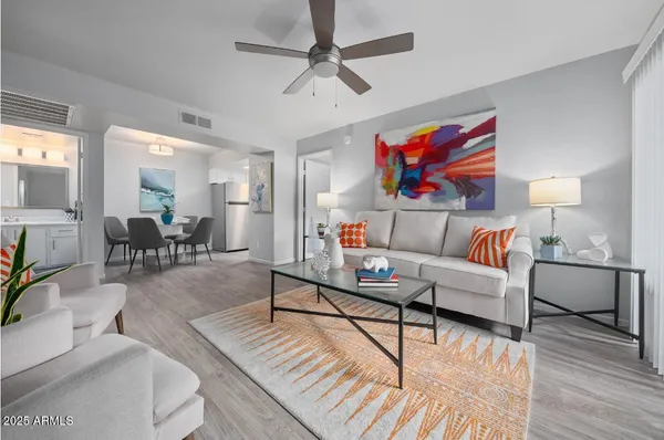 a living room with furniture and wooden floor