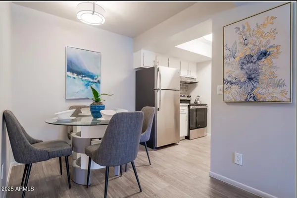 a dining room with furniture and a refrigerator