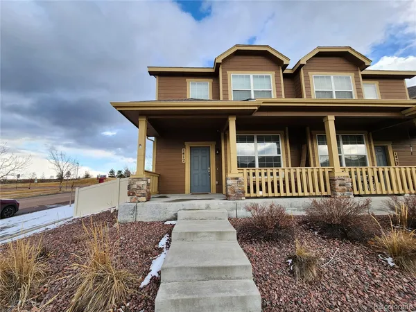 a view of a brick house with large windows