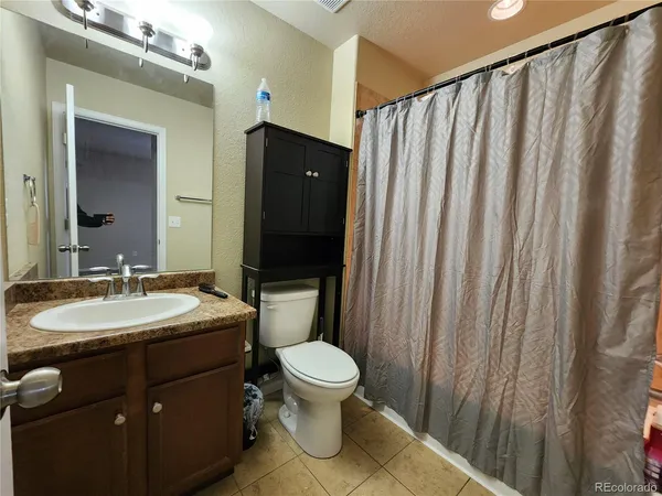 a bathroom with a toilet a sink and a mirror