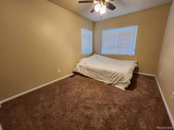 a spacious bedroom with a bed and a chandelier