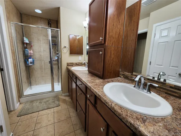 a bathroom with a sink double vanity and shower