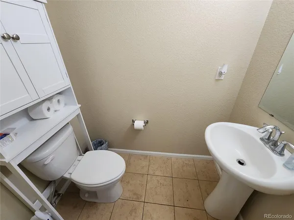 a white toilet sitting next to a bathroom sink